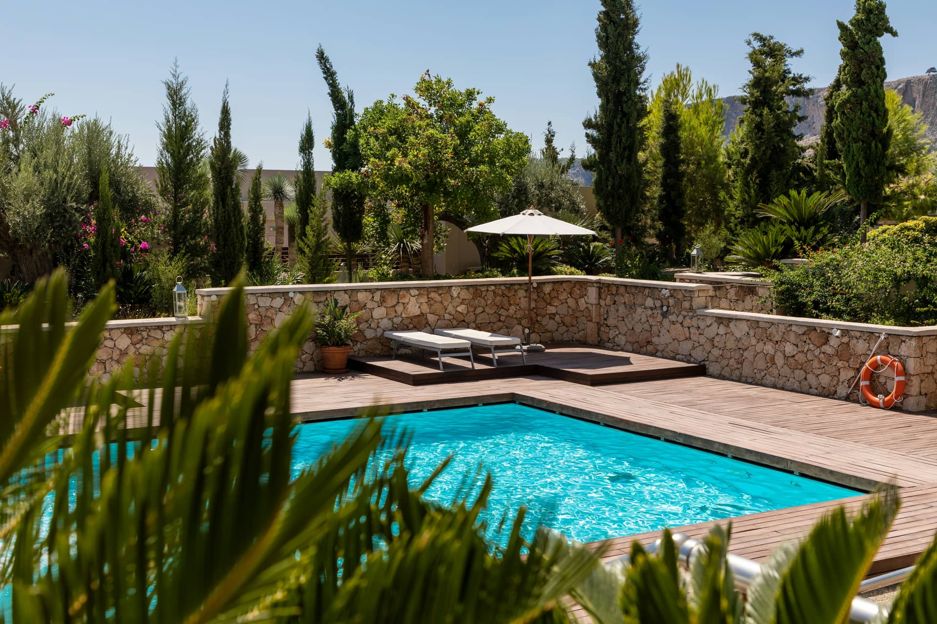 Outdoor pool with sun loungers at a large group holiday home