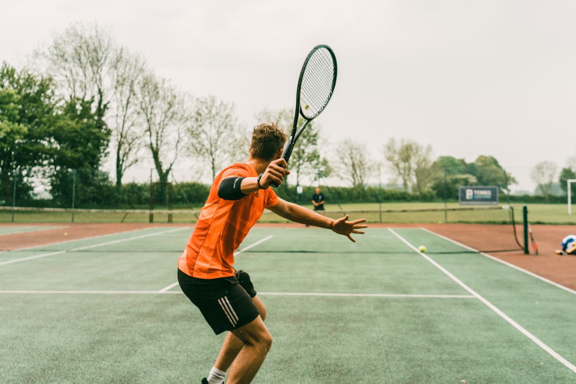 Group playing tennis at a private holiday house