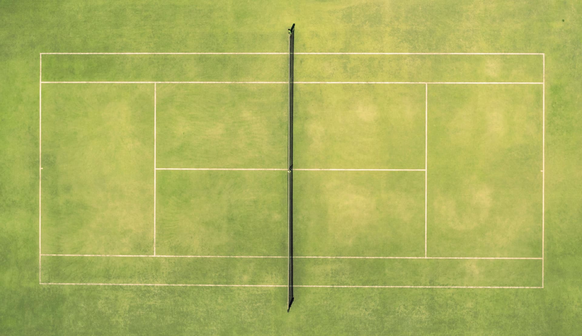 A grass tennis court seen from above