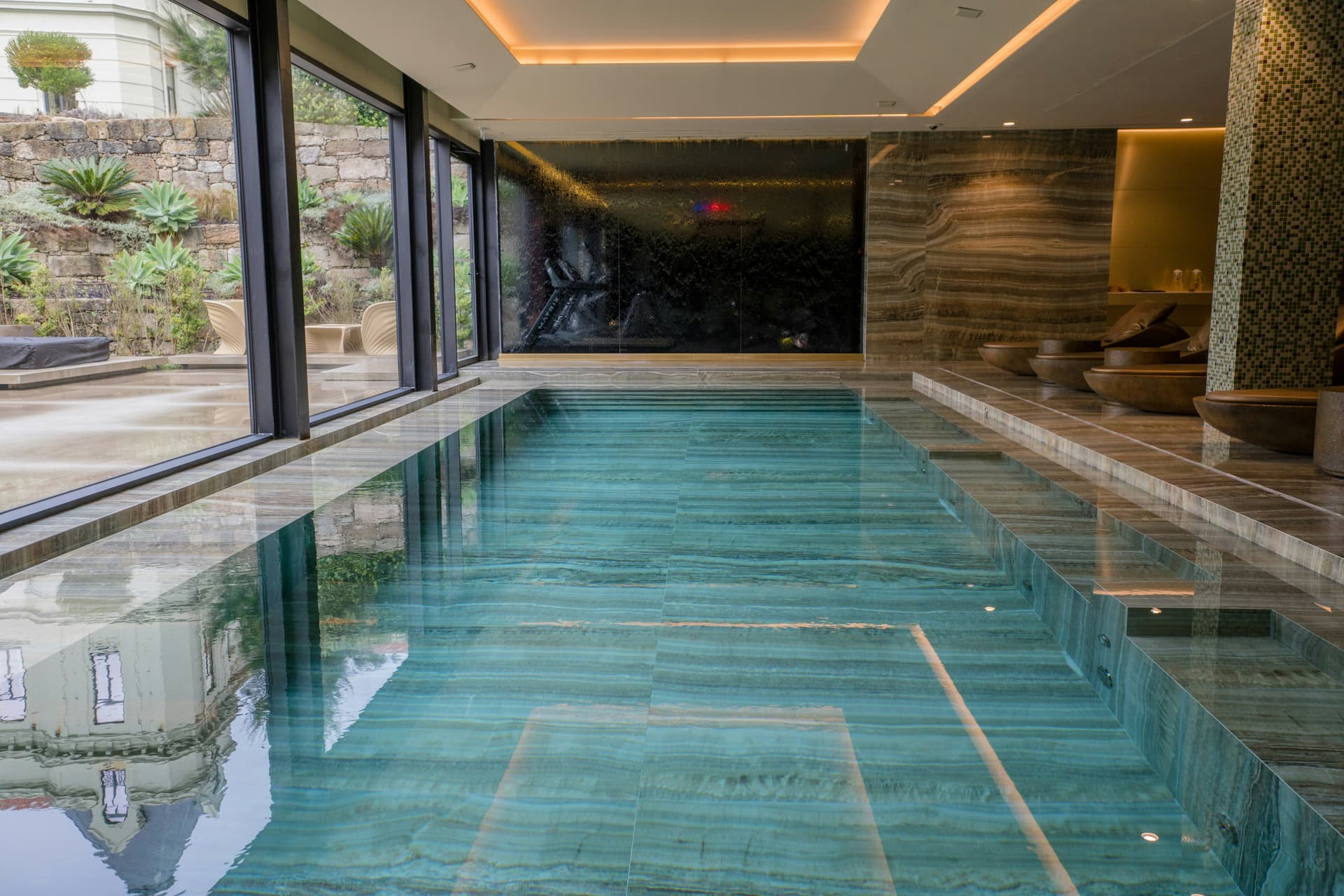 Indoor swimming pool with floor-to-ceiling windows